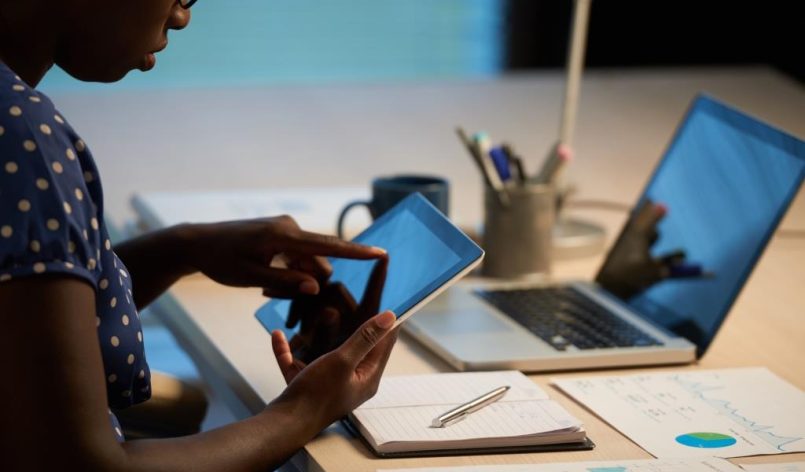 Cropped image of business woman using app on her tablet